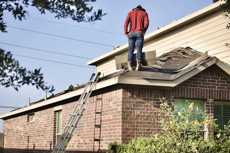Professional roofer working on a residential roof in Pine Aire